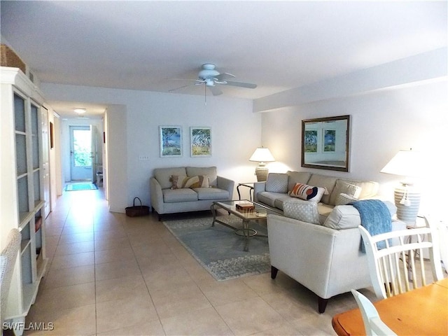 living area with light tile patterned flooring and a ceiling fan