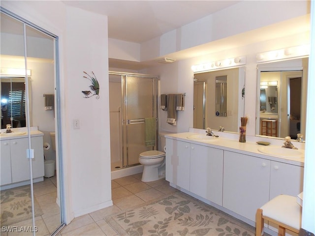 full bathroom featuring a sink, toilet, double vanity, and a shower stall