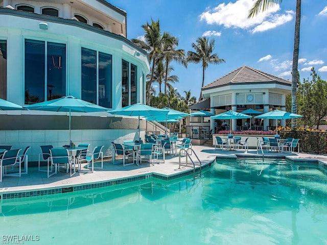 community pool featuring a patio and fence