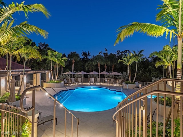 community pool featuring fence and a patio area