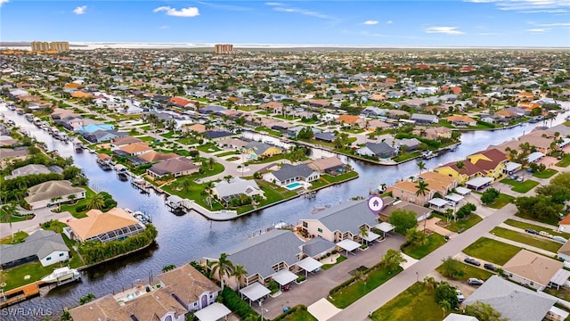 drone / aerial view featuring a residential view and a water view