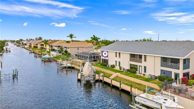 dock area featuring a residential view, a water view, boat lift, and central air condition unit