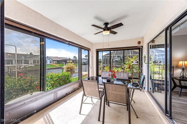 sunroom / solarium featuring ceiling fan