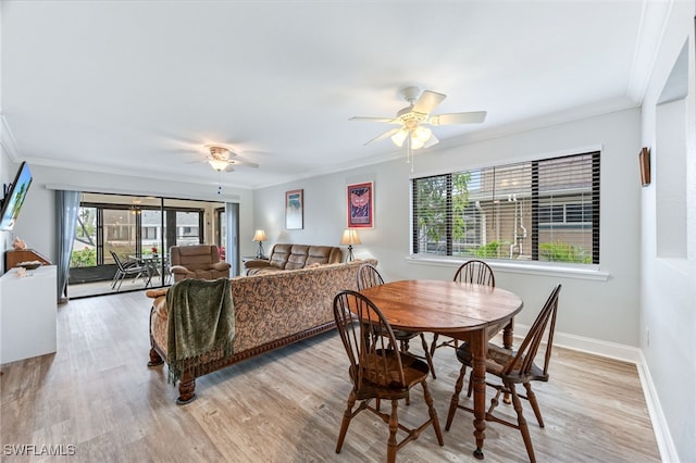 dining area featuring baseboards, a ceiling fan, light wood-style flooring, and crown molding