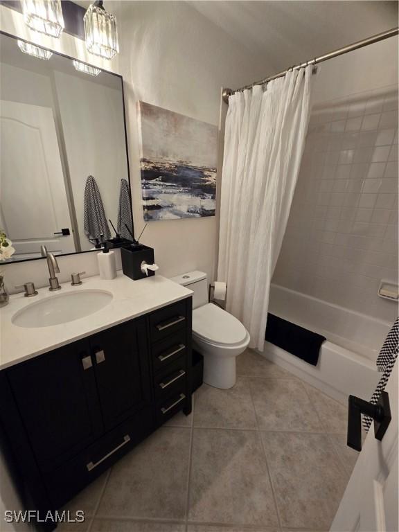 bathroom featuring tile patterned floors, shower / tub combo with curtain, toilet, and vanity