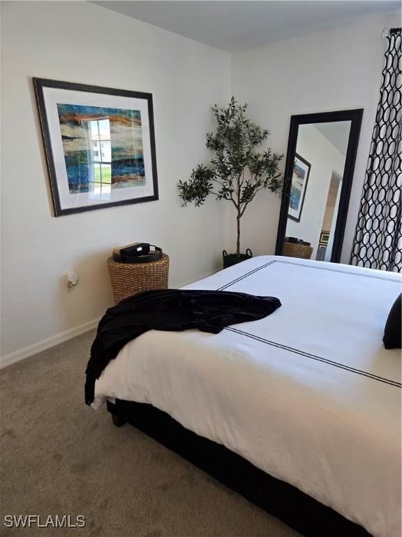 carpeted bedroom featuring baseboards