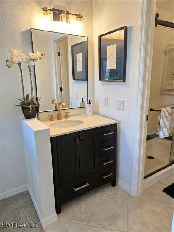 full bathroom with tile patterned flooring, a shower stall, vanity, and baseboards