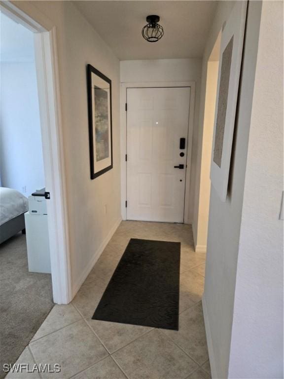 entryway featuring light tile patterned floors and baseboards