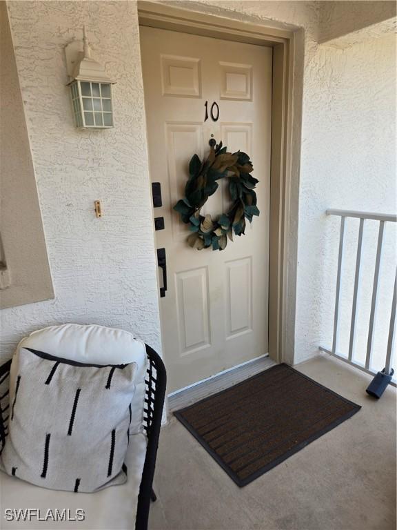 entrance to property featuring stucco siding