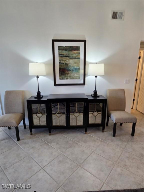 sitting room with light tile patterned floors and visible vents