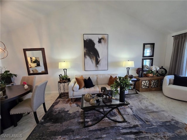 tiled living area with high vaulted ceiling