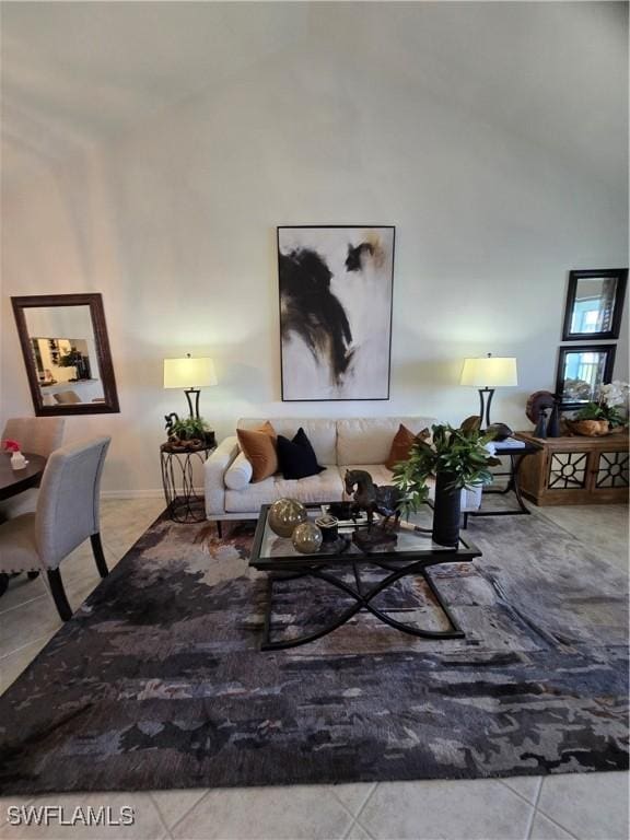 living room with tile patterned floors and high vaulted ceiling