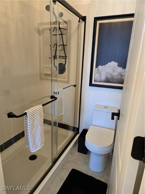 full bath featuring tile patterned floors, a stall shower, and toilet