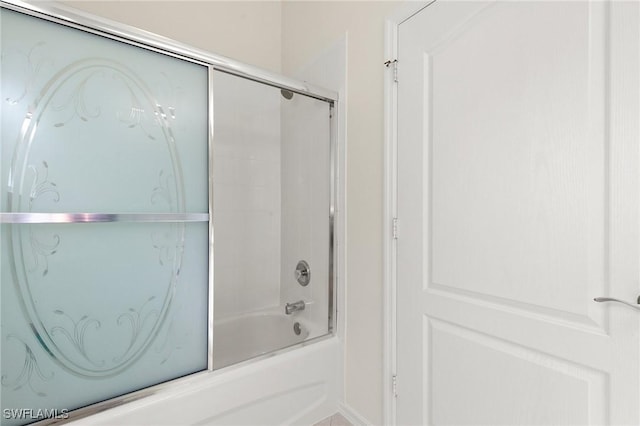 bathroom featuring shower / bath combination with glass door