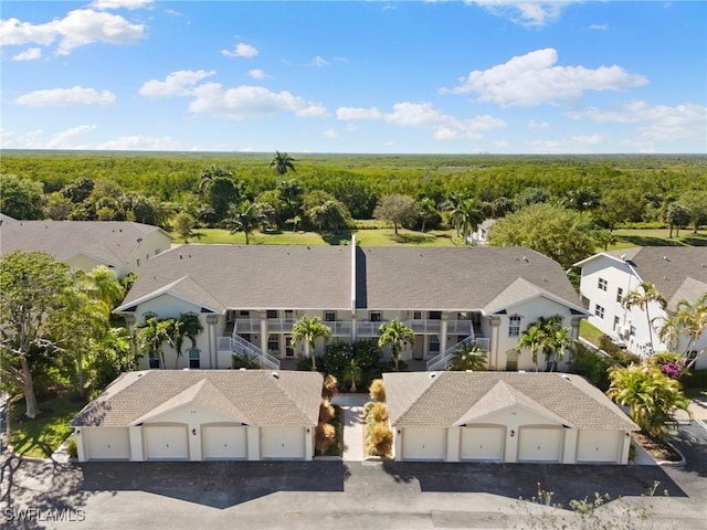 birds eye view of property with a view of trees and a residential view