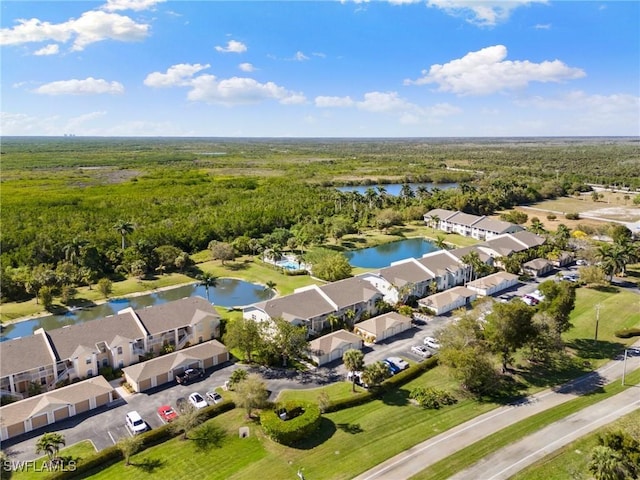 drone / aerial view featuring a residential view and a water view