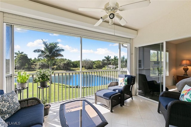 sunroom / solarium with a water view and ceiling fan