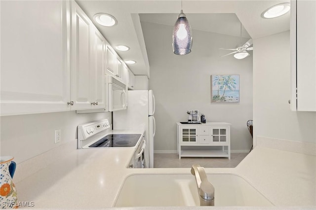 kitchen with decorative light fixtures, light countertops, white cabinets, white appliances, and a ceiling fan