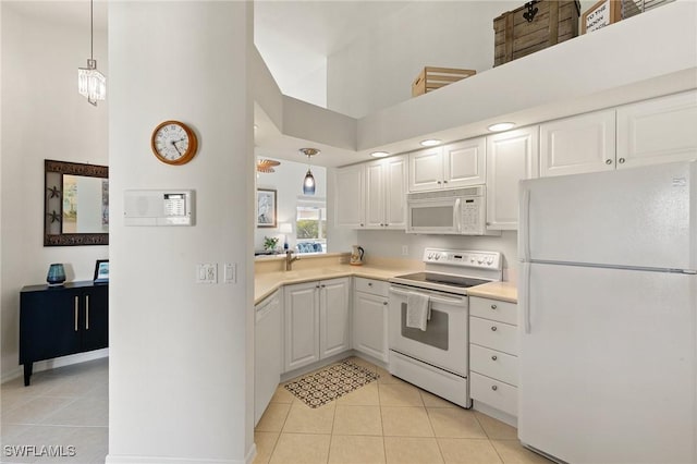 kitchen with white cabinetry, white appliances, a high ceiling, light countertops, and light tile patterned floors