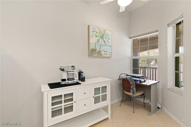 office space featuring light tile patterned floors, baseboards, and a ceiling fan