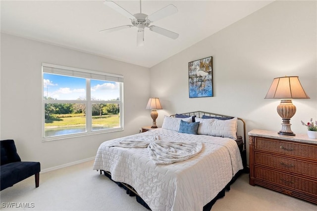 bedroom featuring baseboards, light carpet, lofted ceiling, and a ceiling fan