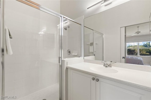 bathroom featuring ensuite bathroom, vanity, ceiling fan, and a shower stall