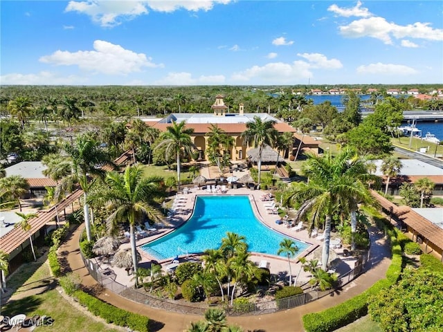 pool featuring a patio and a water view