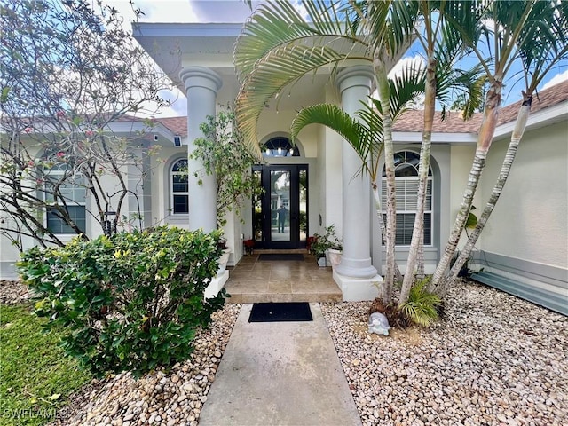 entrance to property with stucco siding