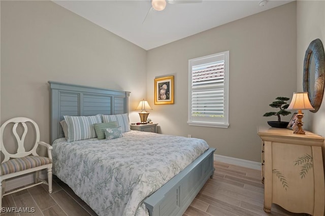 bedroom with ceiling fan, baseboards, and wood tiled floor