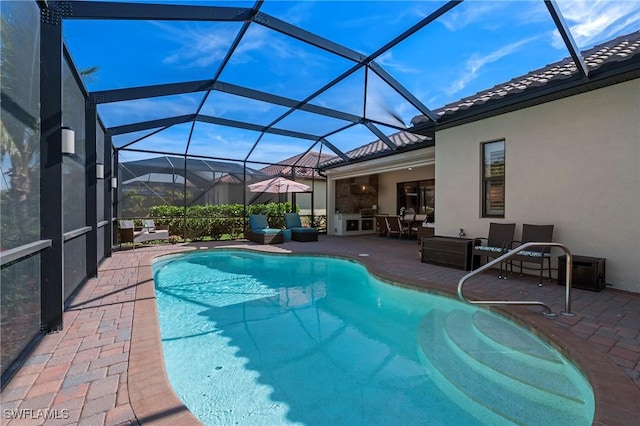 outdoor pool featuring glass enclosure, outdoor lounge area, and a patio area