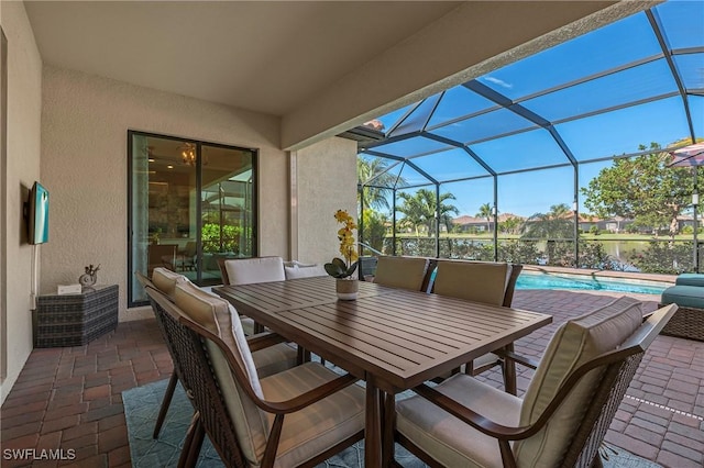 view of patio / terrace featuring outdoor dining space, a lanai, and an outdoor pool