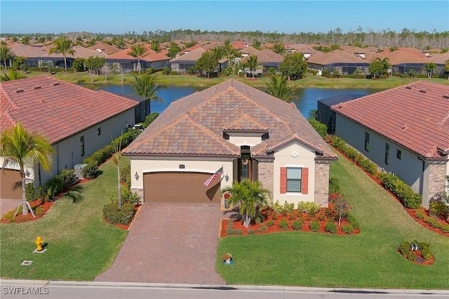 drone / aerial view with a residential view and a water view