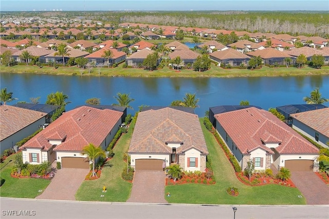 drone / aerial view with a residential view and a water view