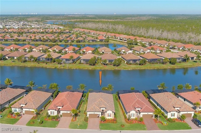 drone / aerial view with a residential view and a water view