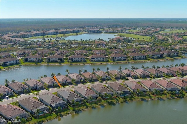 birds eye view of property with a residential view and a water view