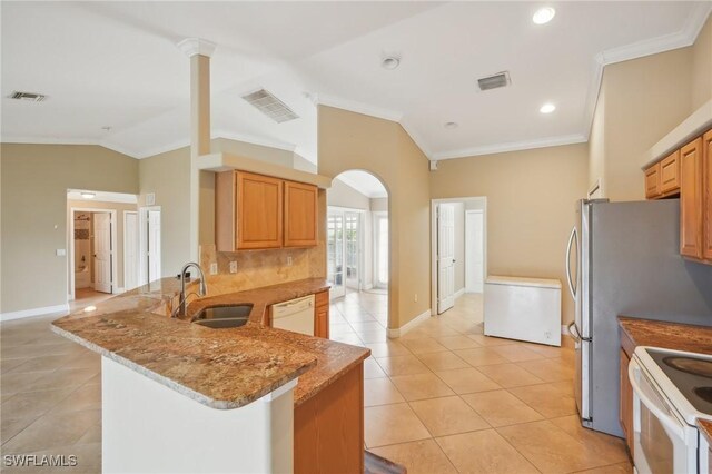 kitchen featuring white appliances, crown molding, visible vents, and a sink