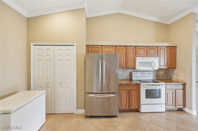 kitchen featuring light tile patterned floors, decorative backsplash, white appliances, and lofted ceiling