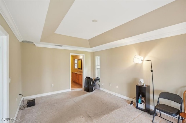 sitting room featuring light carpet, a raised ceiling, baseboards, and ornamental molding