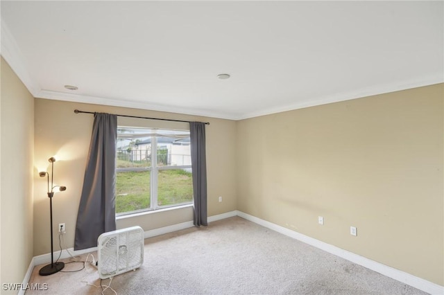 unfurnished room with baseboards, carpet floors, and ornamental molding