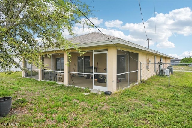 view of home's exterior with stucco siding, central air condition unit, fence, a yard, and a shingled roof