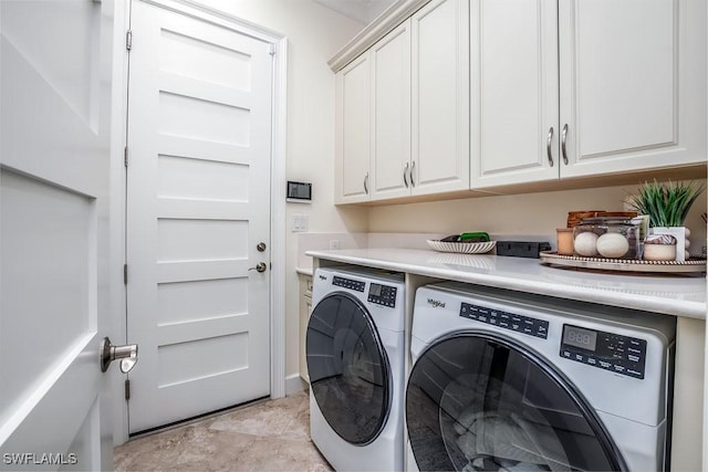 clothes washing area featuring cabinet space and washing machine and dryer