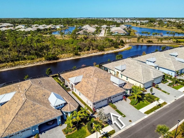 drone / aerial view with a residential view and a water view