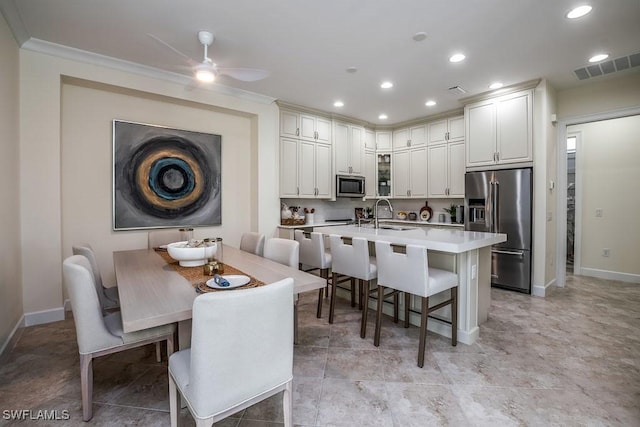 dining space featuring ornamental molding, recessed lighting, visible vents, and ceiling fan