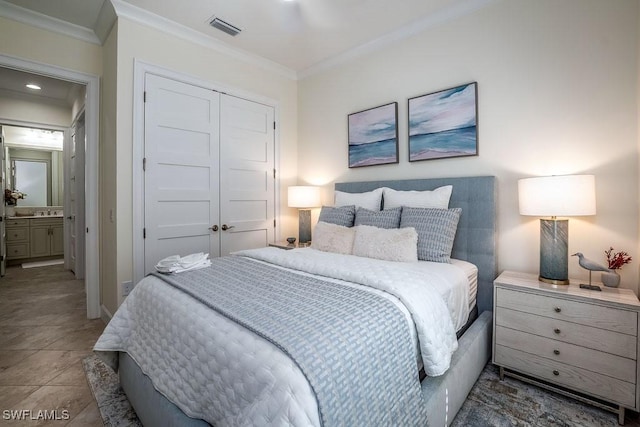 bedroom featuring crown molding, tile patterned floors, visible vents, and a closet