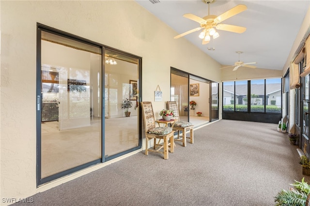 sunroom featuring a ceiling fan and vaulted ceiling