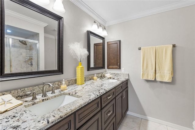 full bath with a shower stall, ornamental molding, and a sink