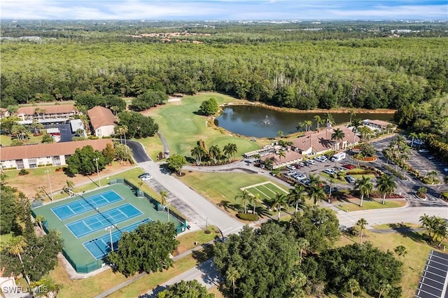 bird's eye view featuring golf course view, a view of trees, and a water view