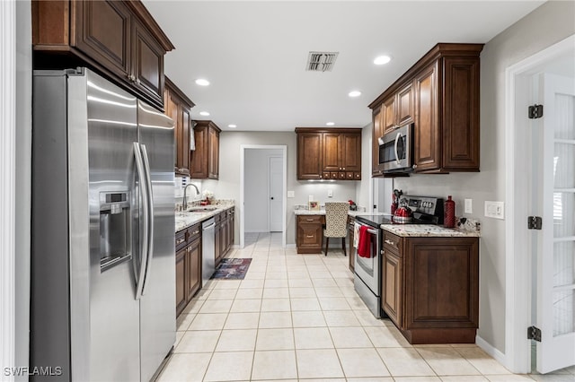 kitchen with visible vents, a sink, recessed lighting, appliances with stainless steel finishes, and light tile patterned floors