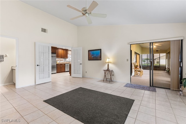 unfurnished living room with visible vents, baseboards, light tile patterned floors, french doors, and a ceiling fan