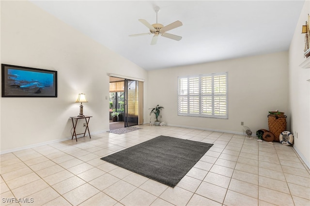 interior space with baseboards, high vaulted ceiling, ceiling fan, and tile patterned flooring